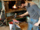 Blacksmith forging red-hot metal with hammer.